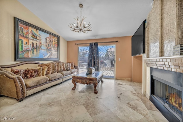 living room with a chandelier, vaulted ceiling, and a brick fireplace