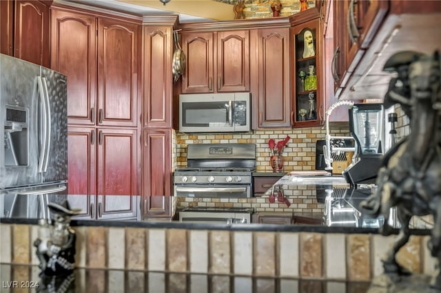 kitchen featuring stainless steel appliances and tasteful backsplash