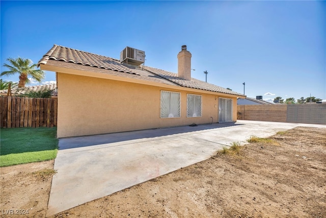 rear view of house featuring a patio area and central AC