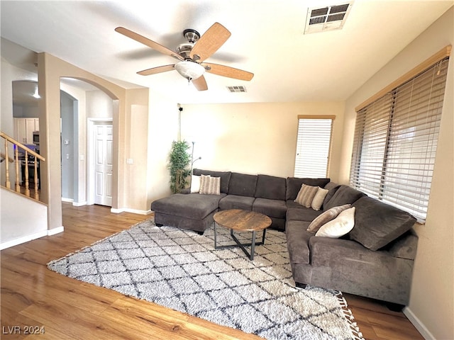 living room featuring ceiling fan and hardwood / wood-style floors