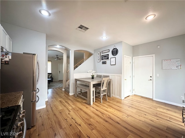 dining space with ceiling fan and light hardwood / wood-style flooring