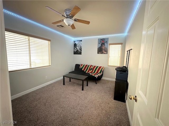 living area with ceiling fan and carpet floors