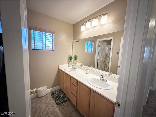 bathroom featuring vanity, tile patterned floors, and plenty of natural light