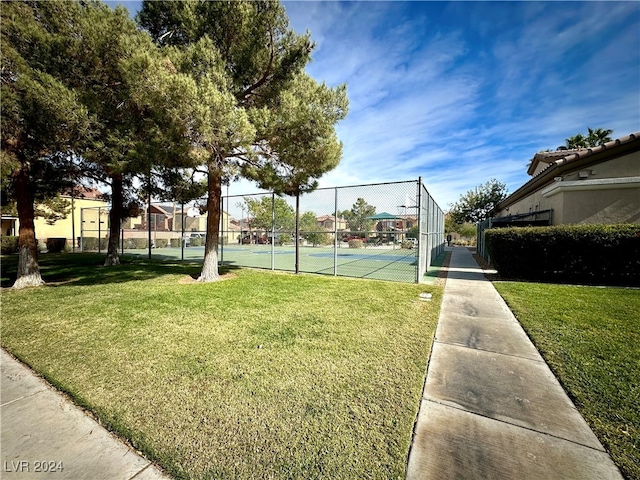 surrounding community featuring a lawn and tennis court