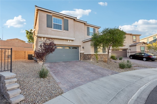 front of property featuring a garage and central AC unit