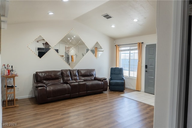 living room featuring hardwood / wood-style floors and vaulted ceiling