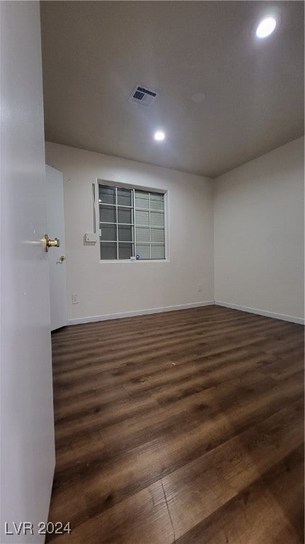 empty room with dark wood-type flooring