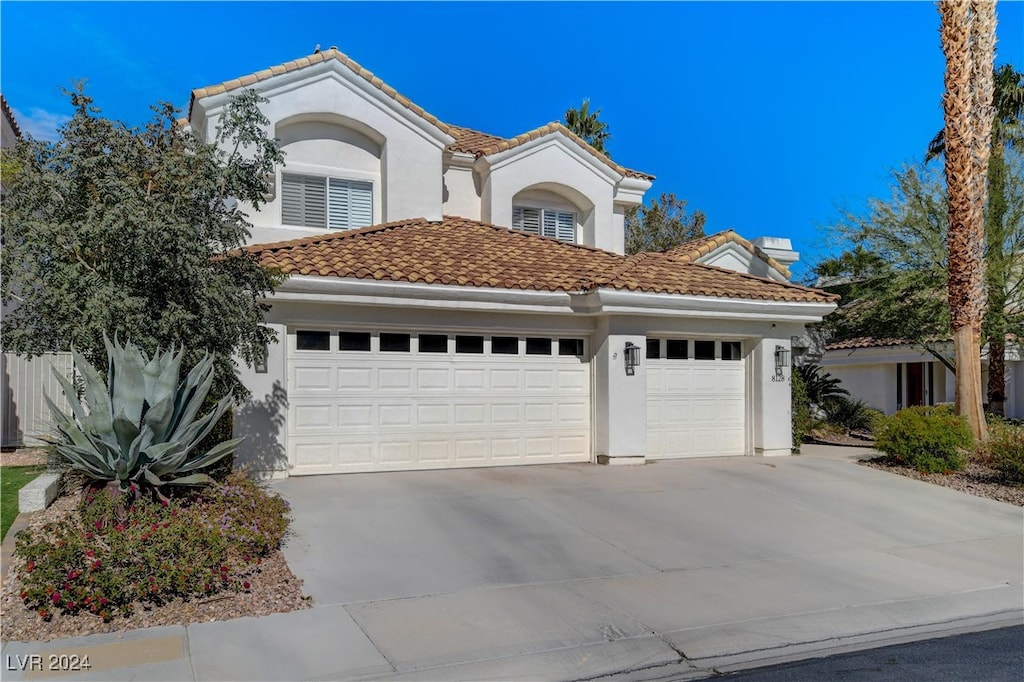 mediterranean / spanish house featuring a garage