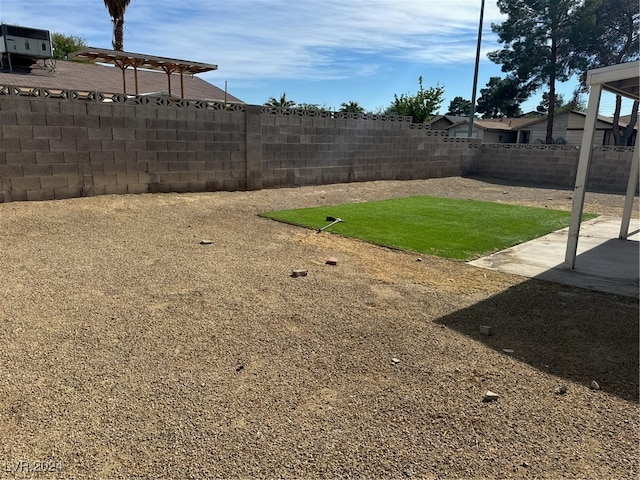 view of yard with central air condition unit and a patio