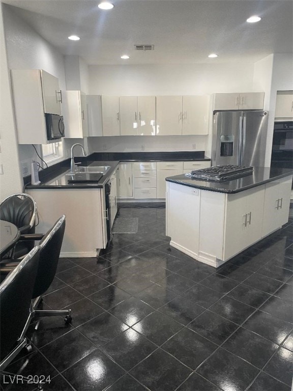 kitchen with white cabinets, sink, and stainless steel appliances