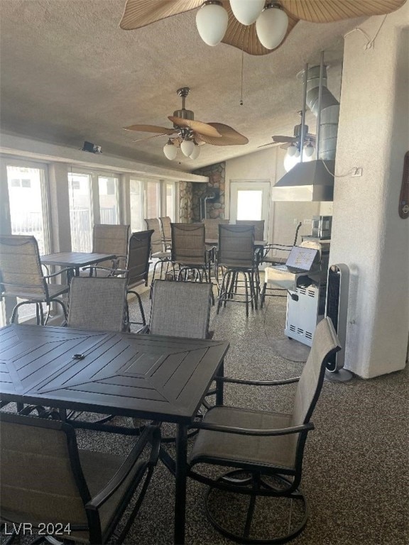 dining area featuring a textured ceiling and ceiling fan