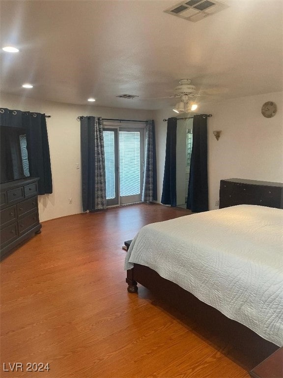 bedroom with ceiling fan and hardwood / wood-style flooring