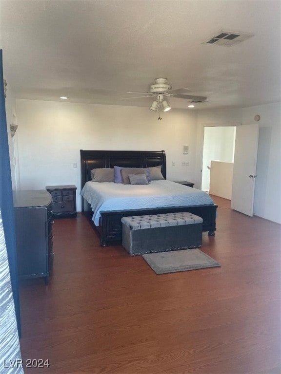 bedroom with dark hardwood / wood-style floors and ceiling fan