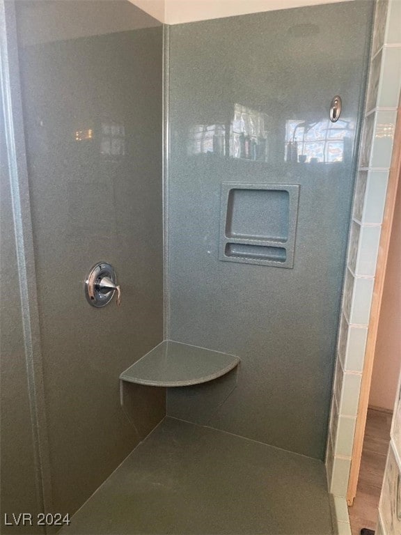 bathroom featuring hardwood / wood-style flooring and walk in shower