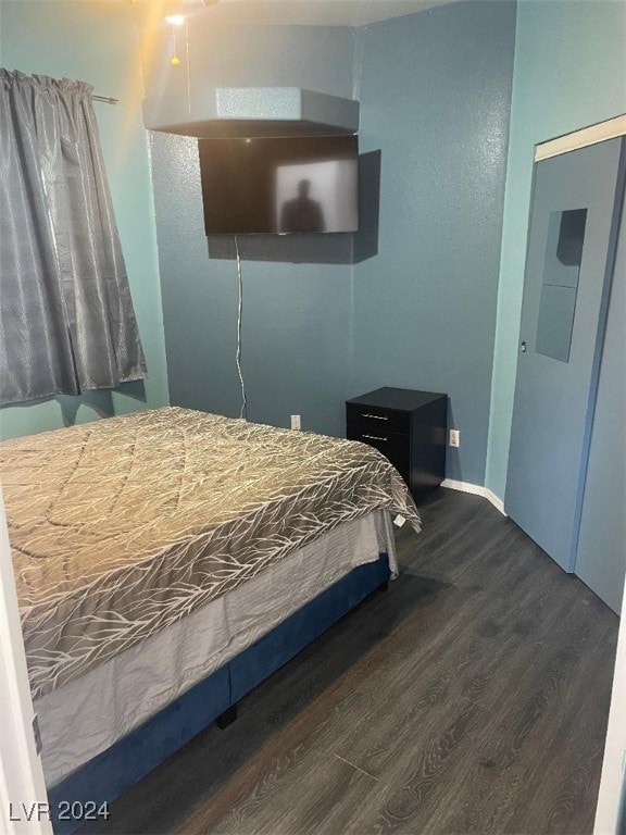 bedroom with dark wood-type flooring