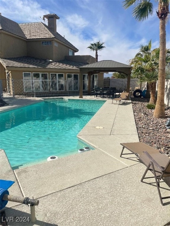 view of swimming pool featuring a gazebo and a patio