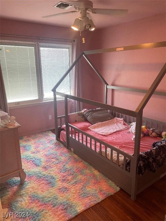 bedroom featuring hardwood / wood-style flooring and ceiling fan