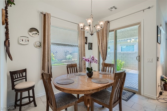 tiled dining space featuring a chandelier