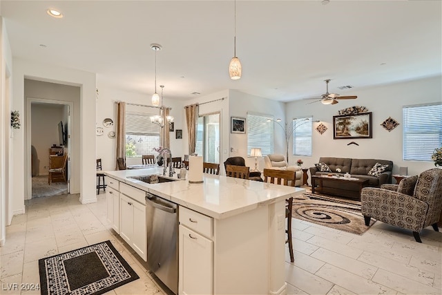 kitchen featuring dishwasher, sink, a center island with sink, and a wealth of natural light