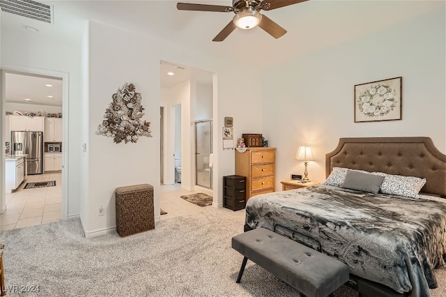 carpeted bedroom with connected bathroom, stainless steel refrigerator with ice dispenser, and ceiling fan