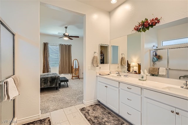 bathroom featuring a shower with door, vanity, and ceiling fan