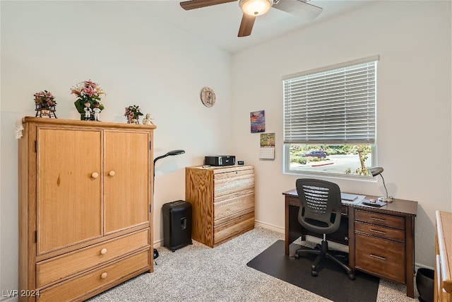 carpeted home office featuring ceiling fan