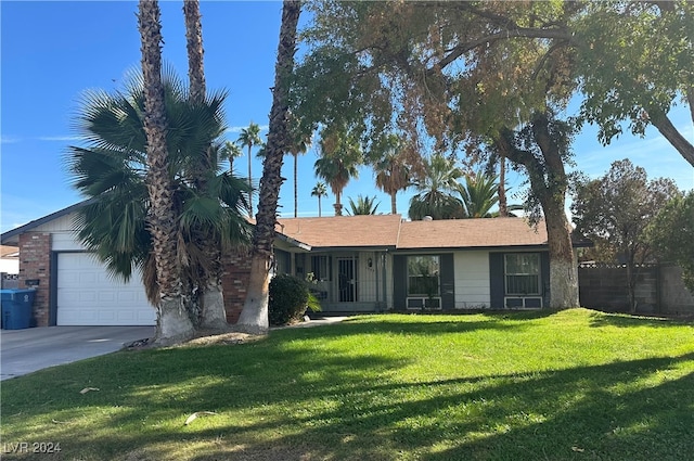 ranch-style house featuring a front yard and a garage