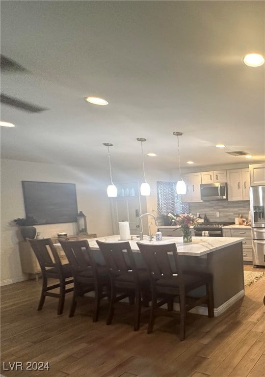 dining area with hardwood / wood-style floors