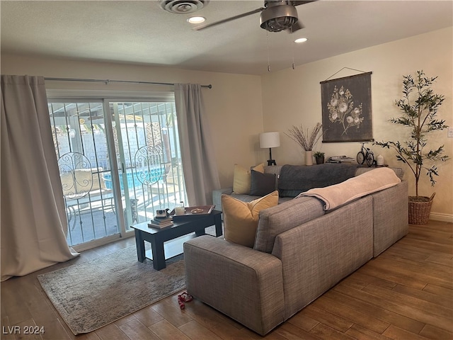 living room featuring ceiling fan and hardwood / wood-style flooring