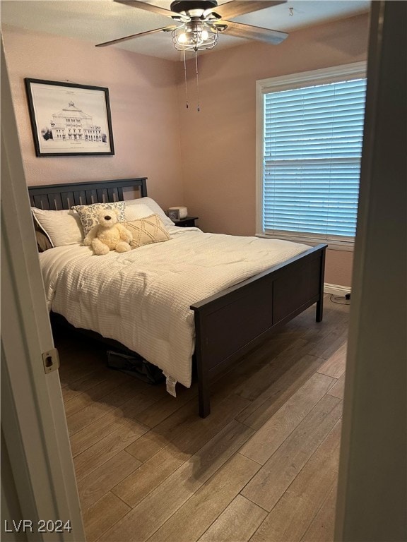 bedroom featuring wood-type flooring and ceiling fan