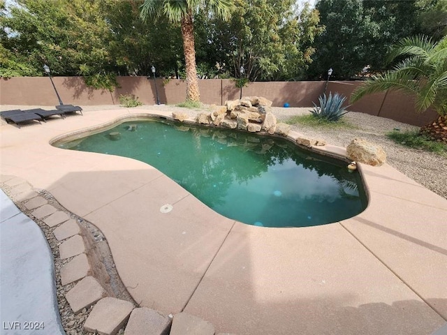 view of swimming pool with a patio area