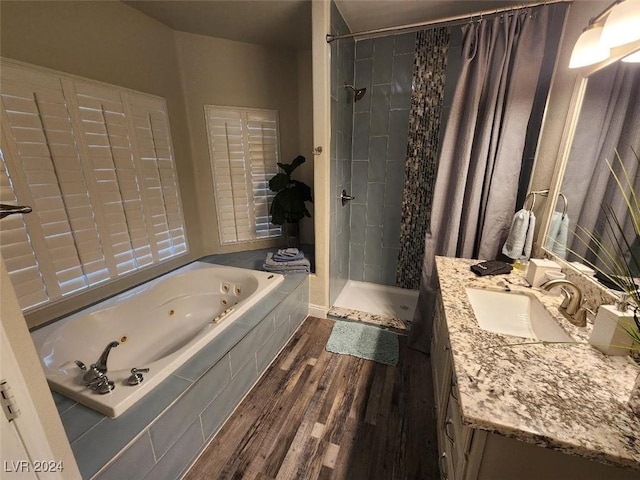 bathroom featuring separate shower and tub, vanity, and hardwood / wood-style flooring