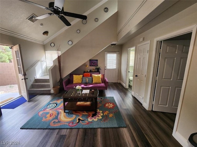 living room featuring a wealth of natural light, dark hardwood / wood-style flooring, crown molding, and vaulted ceiling