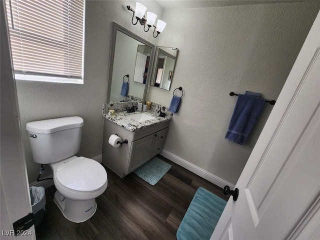 bathroom featuring hardwood / wood-style floors, vanity, and toilet