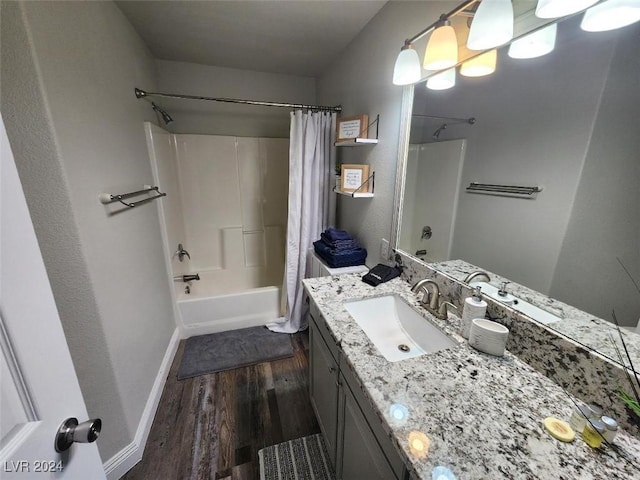 bathroom with wood-type flooring, vanity, and shower / tub combo with curtain