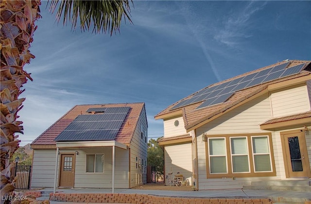 view of property exterior featuring solar panels