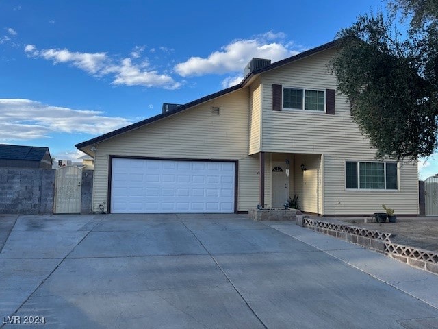 view of front of home featuring a garage and central AC