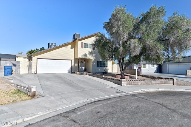 view of property featuring cooling unit and a garage