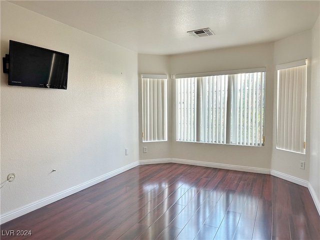 empty room featuring dark hardwood / wood-style flooring