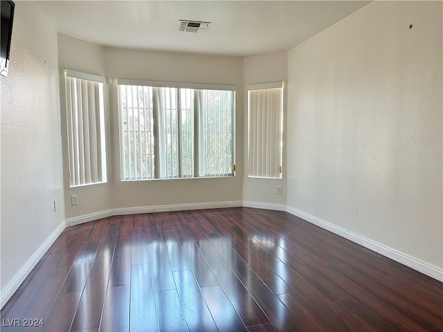 unfurnished room featuring dark wood-type flooring