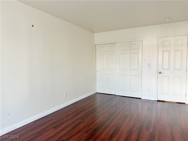 unfurnished bedroom featuring dark hardwood / wood-style flooring