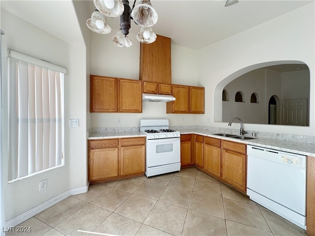 kitchen with a chandelier, sink, light tile patterned flooring, and white appliances