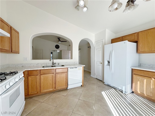 kitchen with white appliances, ceiling fan, vaulted ceiling, and sink