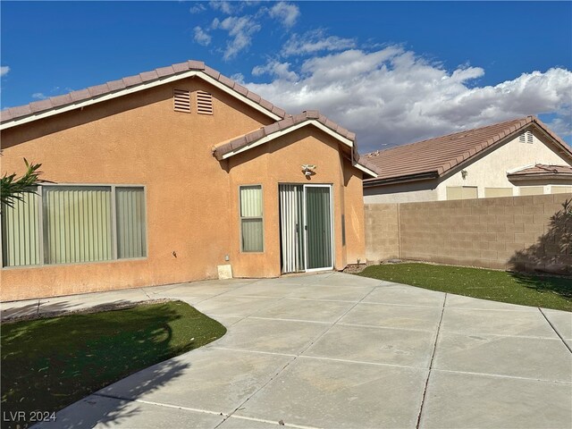 back of house with a patio