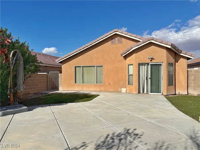 rear view of house featuring a patio