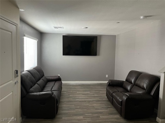 living room with hardwood / wood-style floors and a textured ceiling