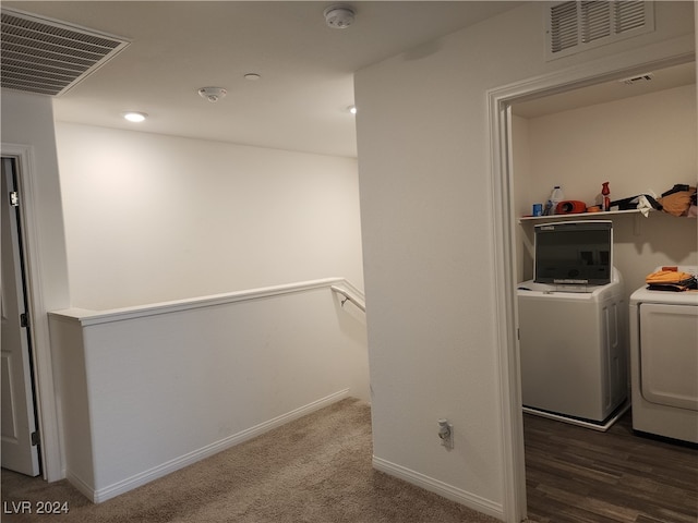 washroom with washer and clothes dryer and dark wood-type flooring