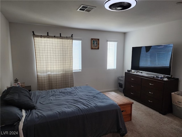 bedroom featuring light colored carpet