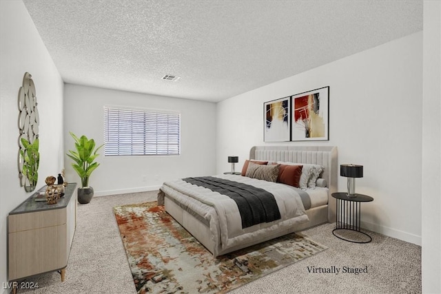 carpeted bedroom with a textured ceiling