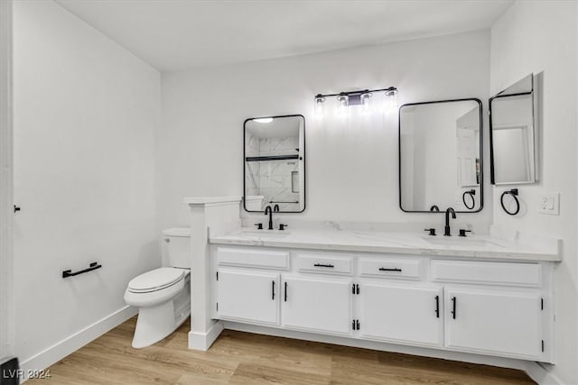 bathroom with toilet, a shower with shower door, wood-type flooring, and vanity